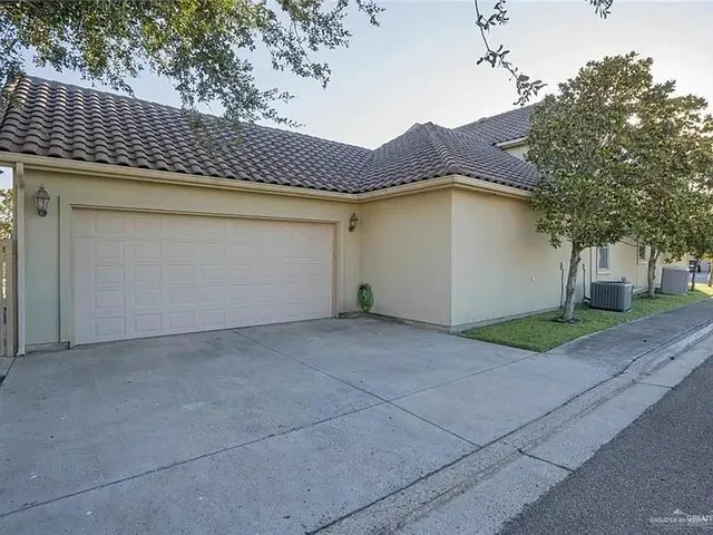 a view of a house with a yard and garage