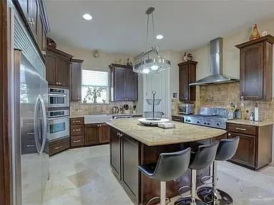 a kitchen with cabinets a sink stove and refrigerator