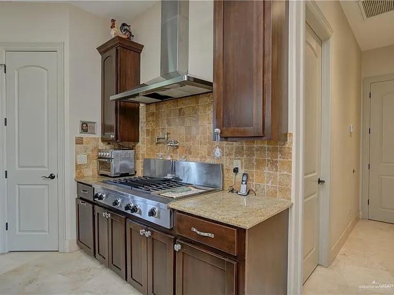 3429 South 3rd Street McAllen, TX 78503 - Photo 8 of 25 a kitchen with a stove and a refrigerator