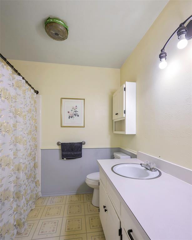 1113 West Will White Road Kemp, TX 75143 - Photo 11 of 22 a bathroom with a granite countertop sink mirror vanity and toilet