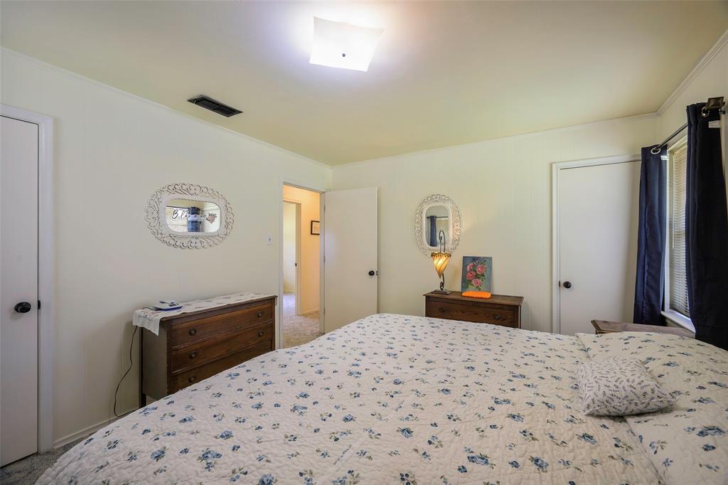 1113 West Will White Road Kemp, TX 75143 - Photo 15 of 22 a bedroom with a bed and a dresser in it