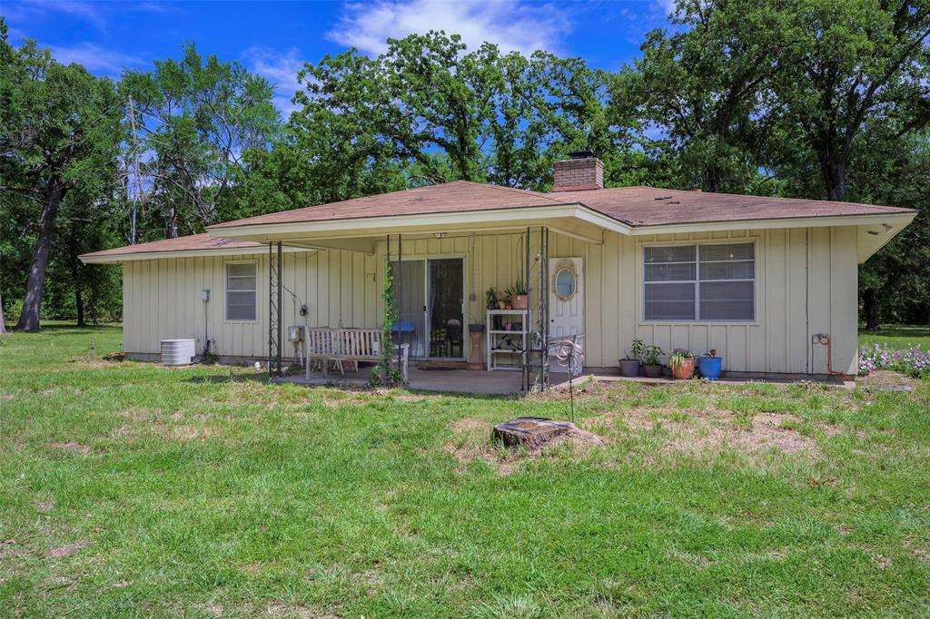 1113 West Will White Road Kemp, TX 75143 - Photo 16 of 22 a view of a house with backyard sitting area and garden