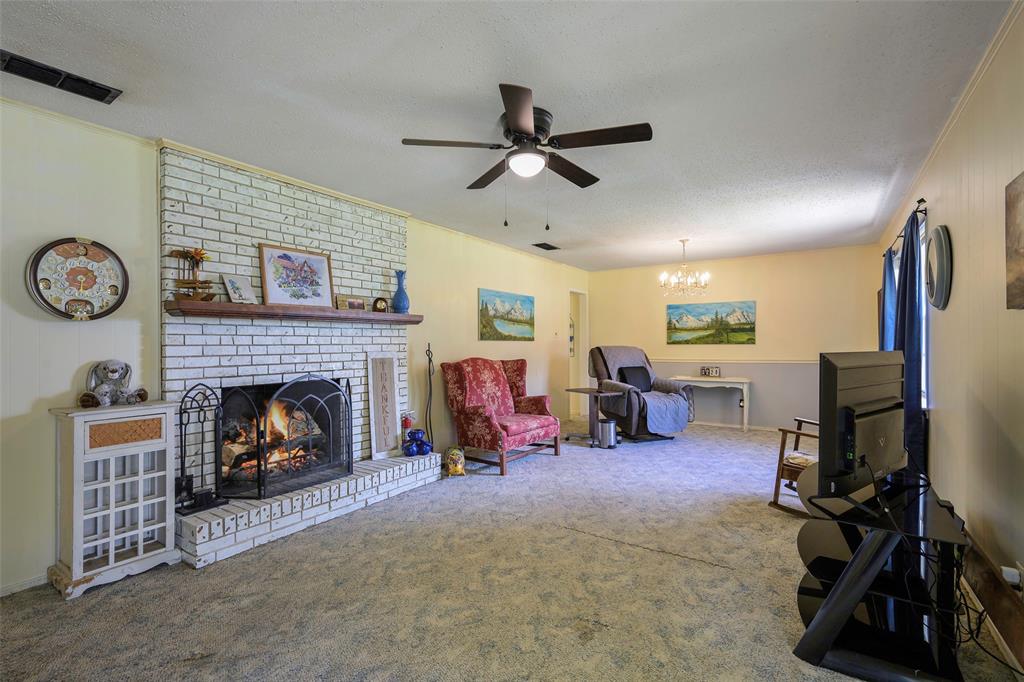 1113 West Will White Road Kemp, TX 75143 - Photo 2 of 22 a living room with furniture and a fireplace