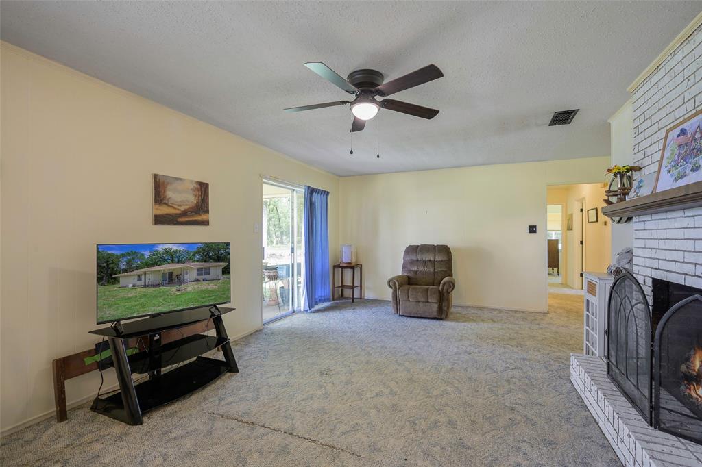 1113 West Will White Road Kemp, TX 75143 - Photo 4 of 22 a living room with furniture and a fireplace