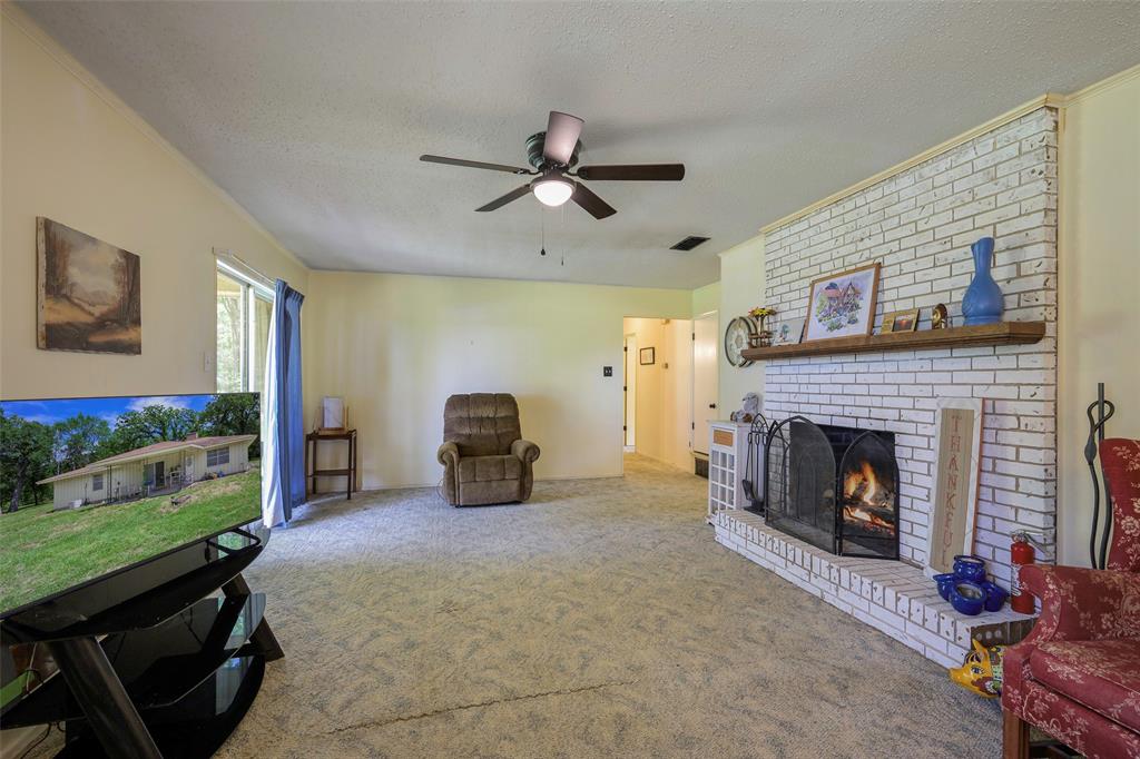 1113 West Will White Road Kemp, TX 75143 - Photo 5 of 22 a living room with furniture and a fireplace