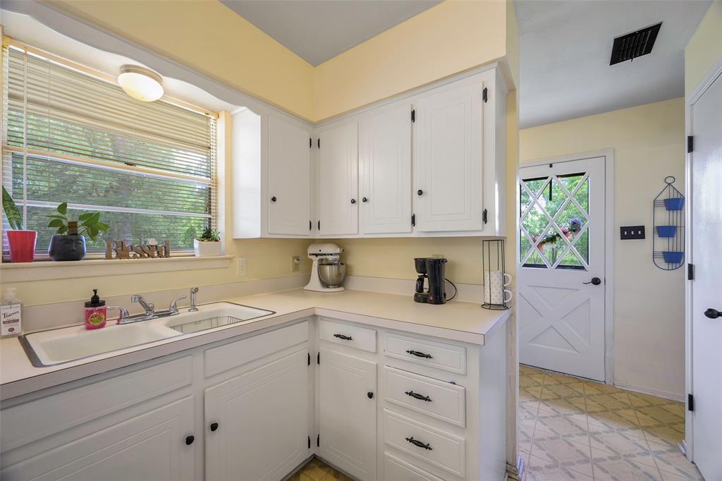 1113 West Will White Road Kemp, TX 75143 - Photo 8 of 22 a kitchen with white cabinets and window