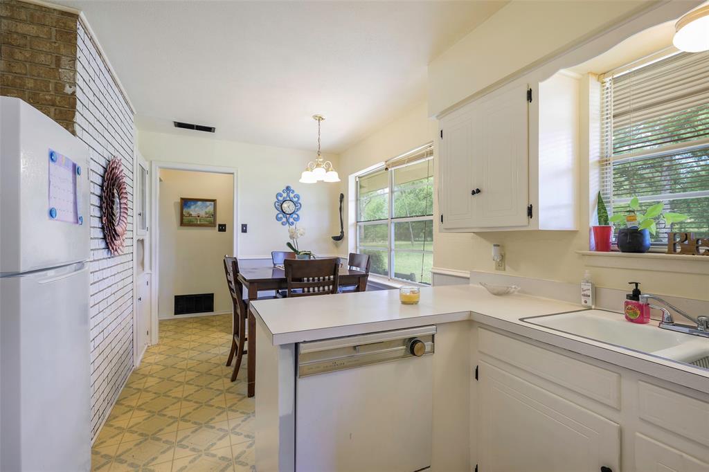 1113 West Will White Road Kemp, TX 75143 - Photo 9 of 22 a kitchen that has a cabinets and a stove