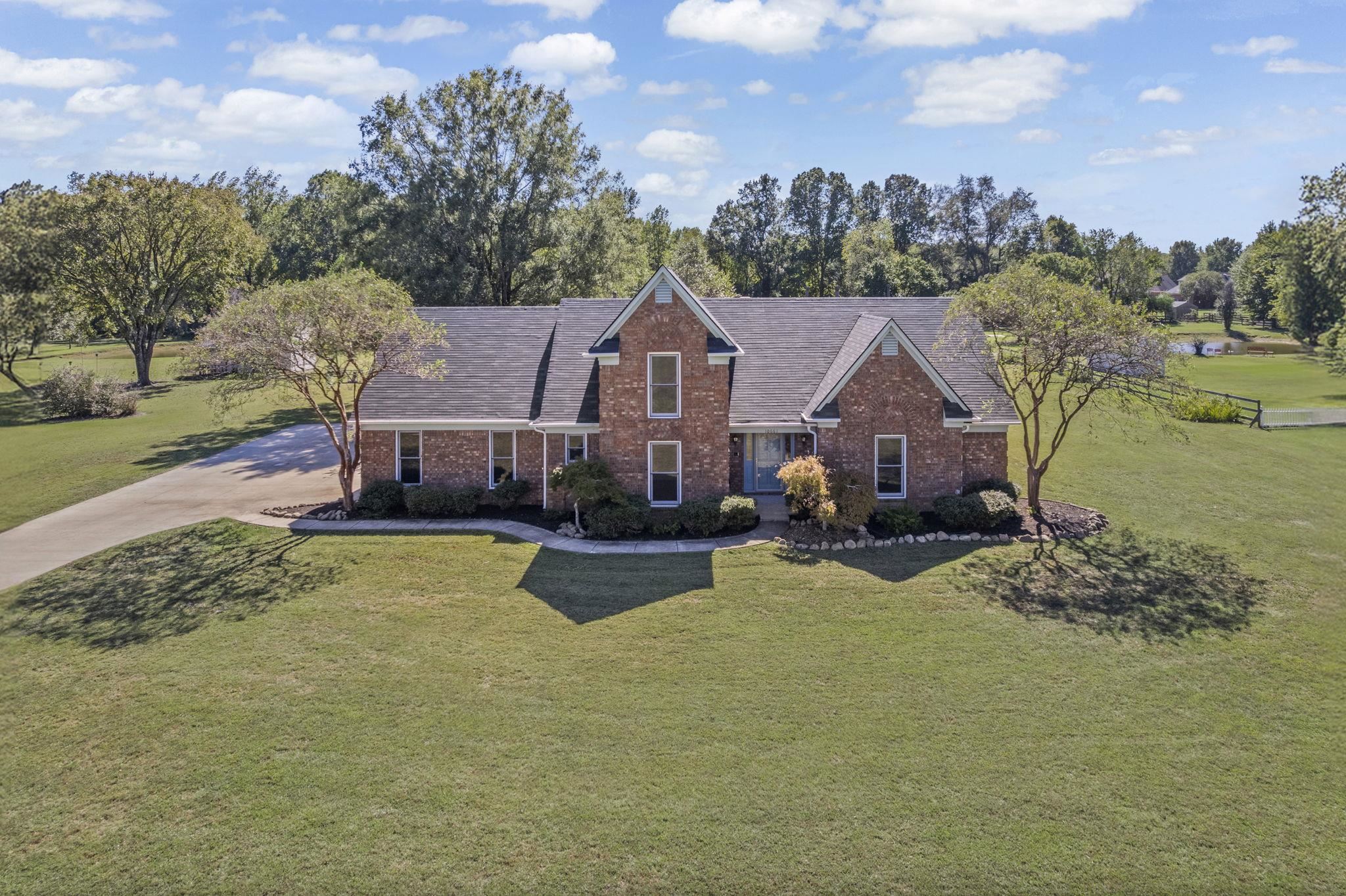 10661 Chapel Hill Road Lakeland, TN 38002 - Photo 1 of 40 a view of a house with a big yard and large trees