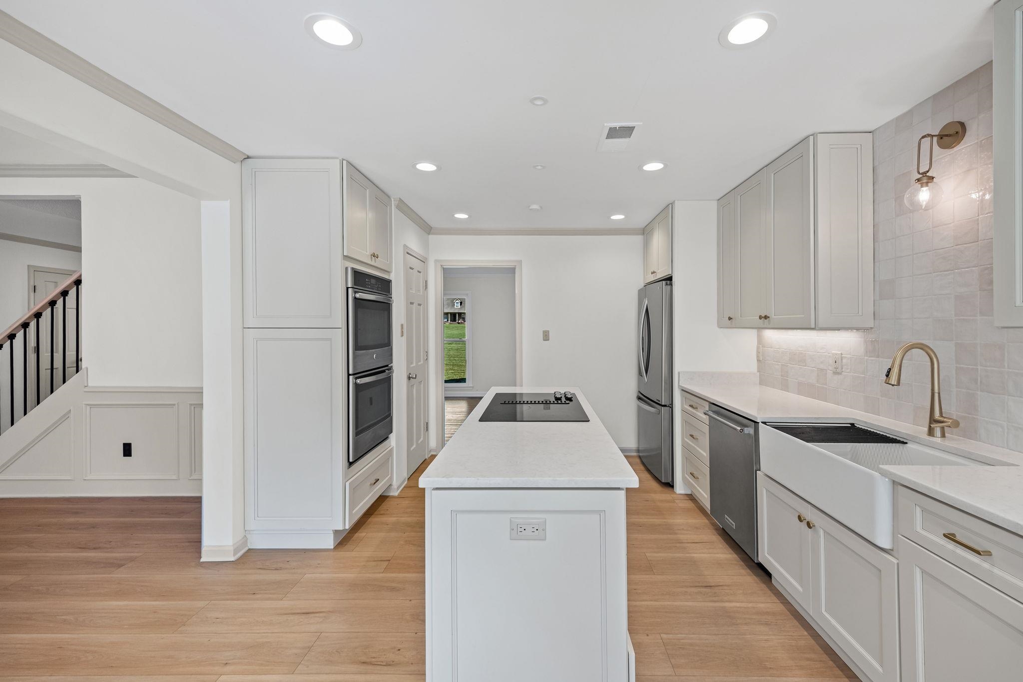 10661 Chapel Hill Road Lakeland, TN 38002 - Photo 18 of 40 a kitchen with white cabinets and stainless steel appliances