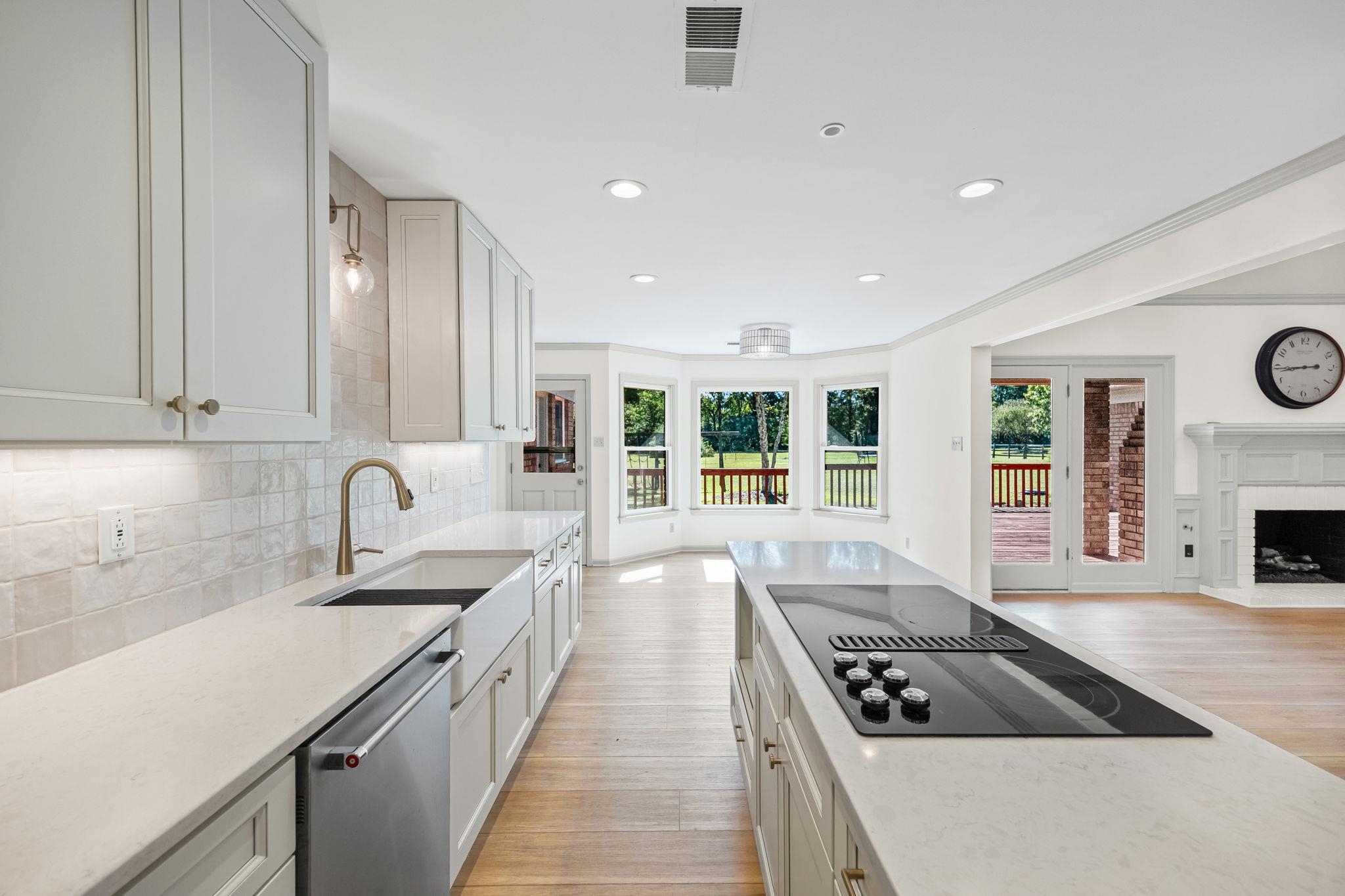 10661 Chapel Hill Road Lakeland, TN 38002 - Photo 38 of 40 a large kitchen with granite countertop a large stove a sink dishwasher and cabinets with wooden floor