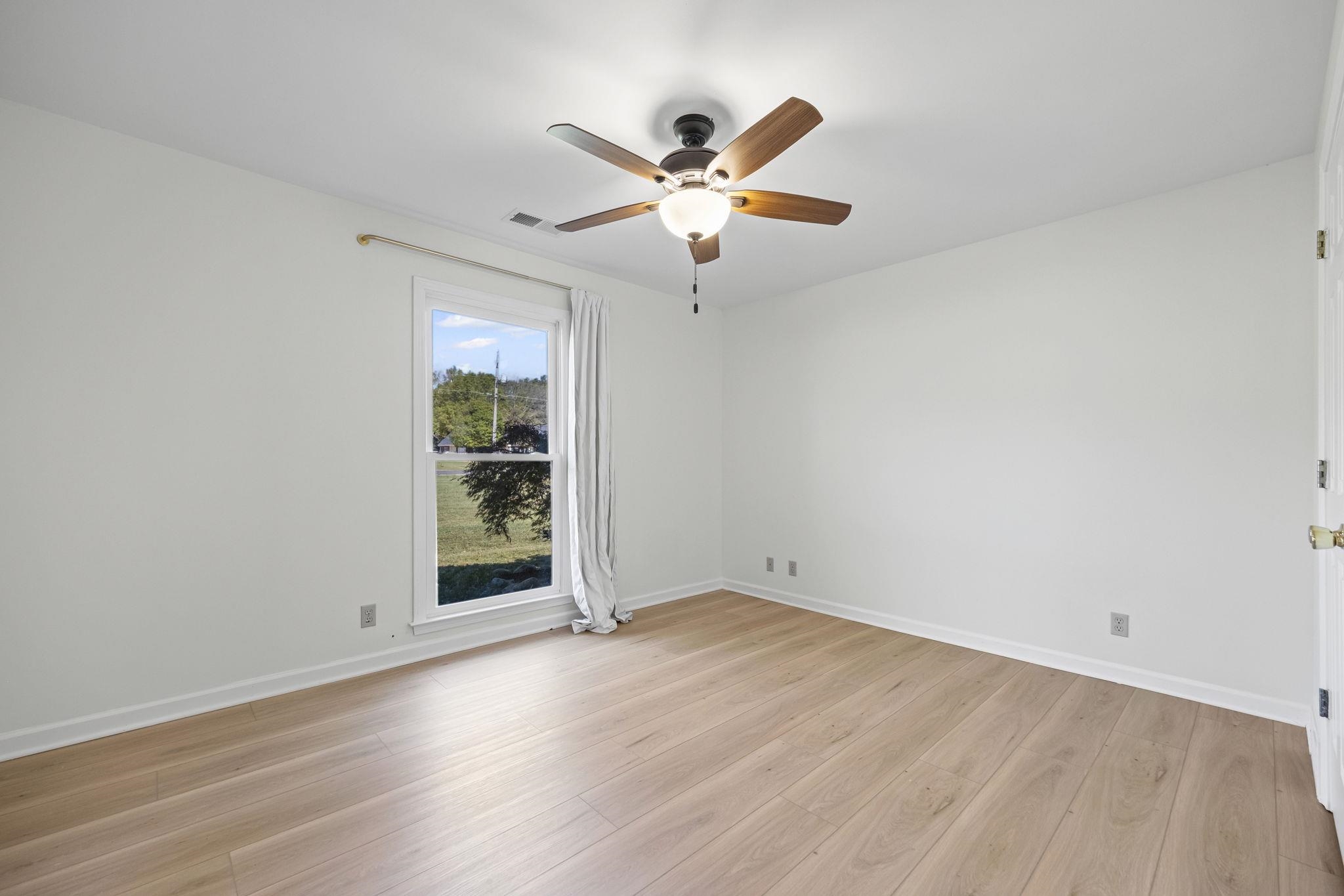 10661 Chapel Hill Road Lakeland, TN 38002 - Photo 23 of 40 wooden floor in an empty room with a window