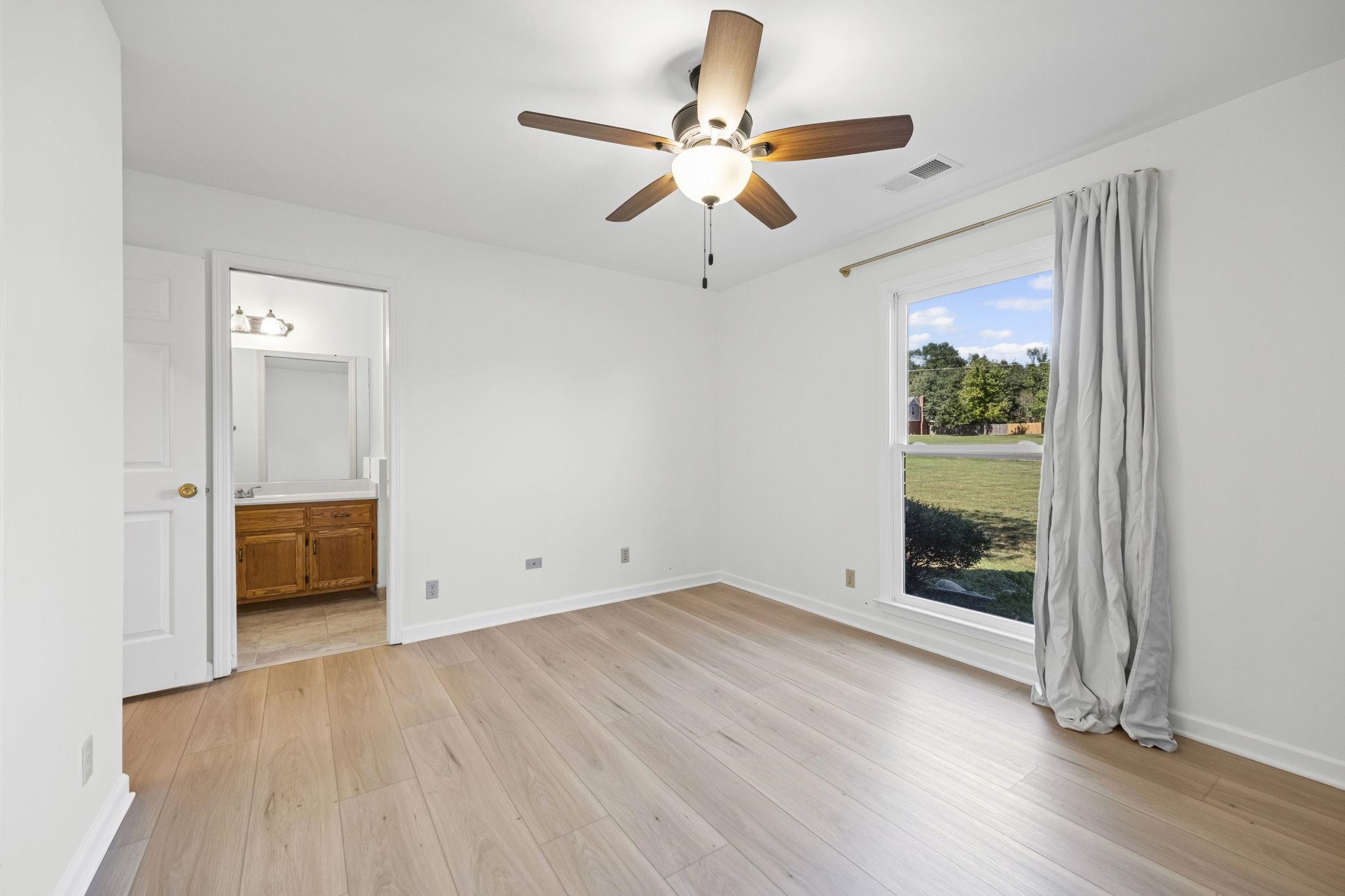 10661 Chapel Hill Road Lakeland, TN 38002 - Photo 24 of 40 wooden floor in an empty room with a window