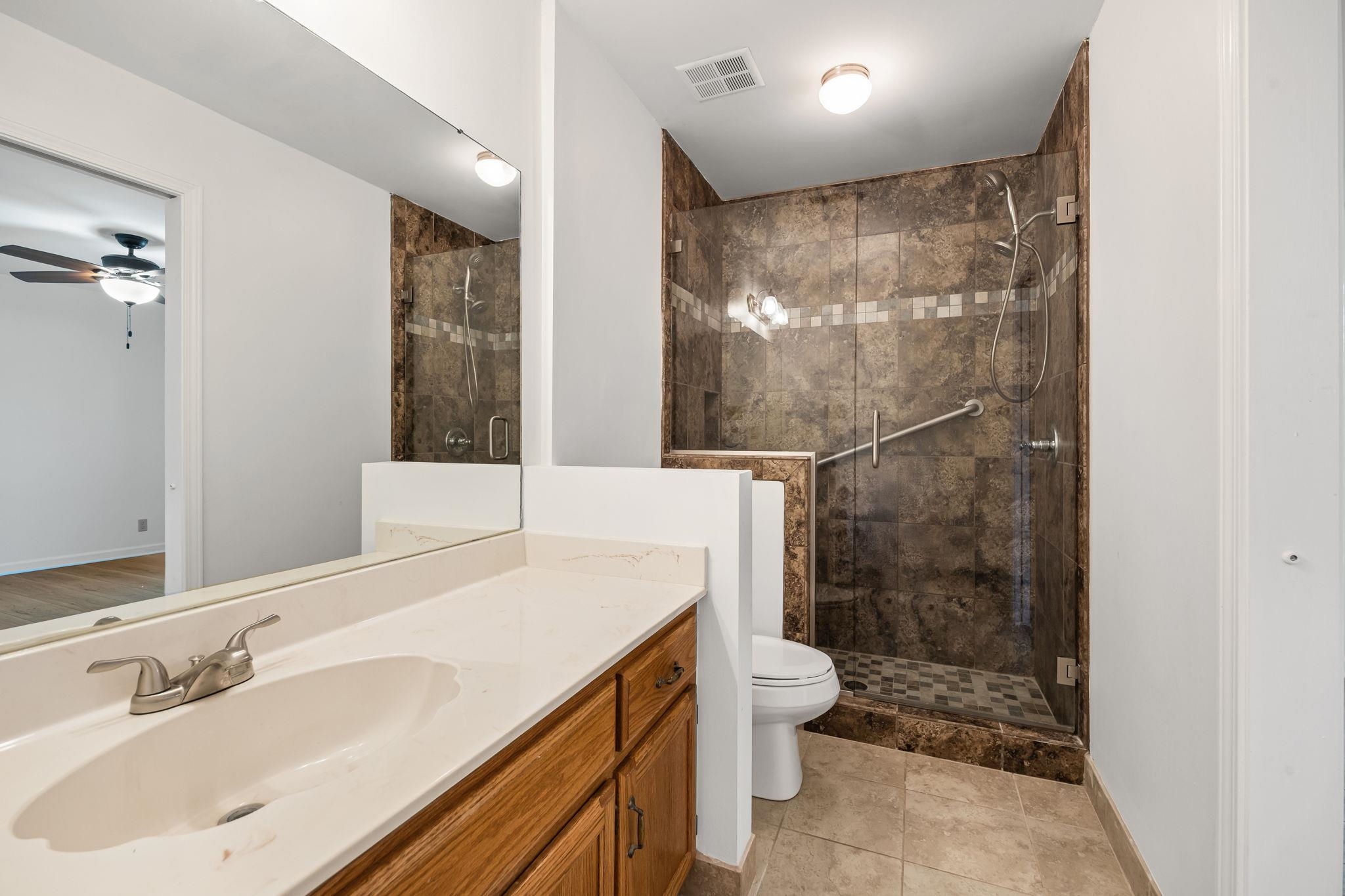 10661 Chapel Hill Road Lakeland, TN 38002 - Photo 25 of 40 a bathroom with a sink toilet and shower