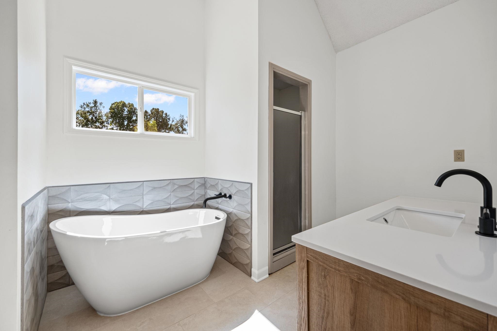 10661 Chapel Hill Road Lakeland, TN 38002 - Photo 27 of 40 a white bath tub sitting in a bathroom