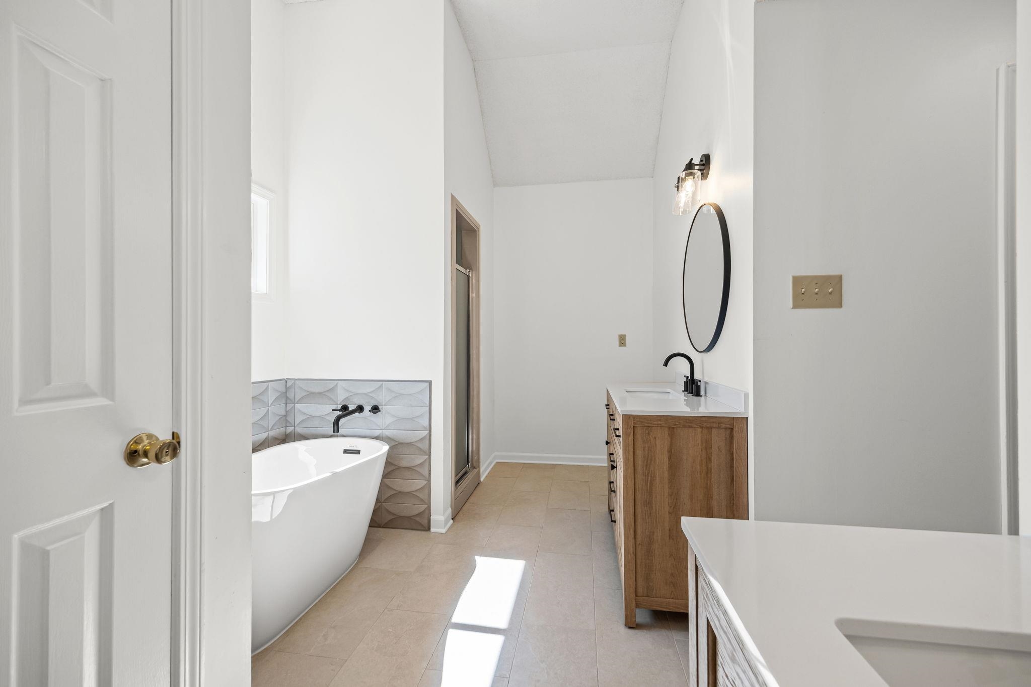 10661 Chapel Hill Road Lakeland, TN 38002 - Photo 28 of 40 a bathroom with a tub a sink and mirror