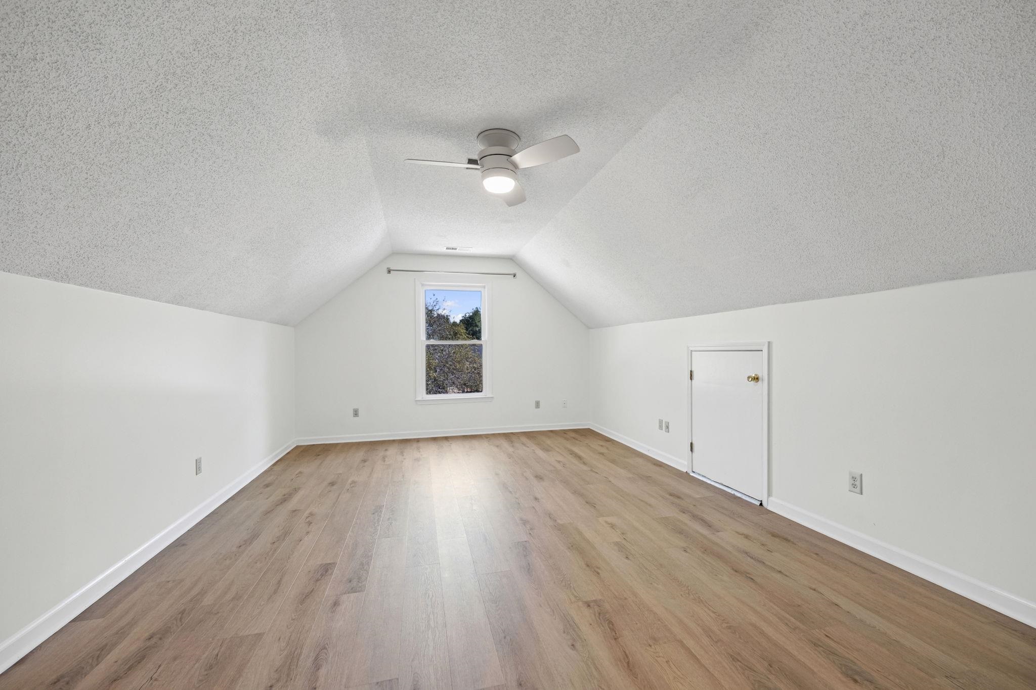 10661 Chapel Hill Road Lakeland, TN 38002 - Photo 31 of 40 an empty room with wooden floor and fan