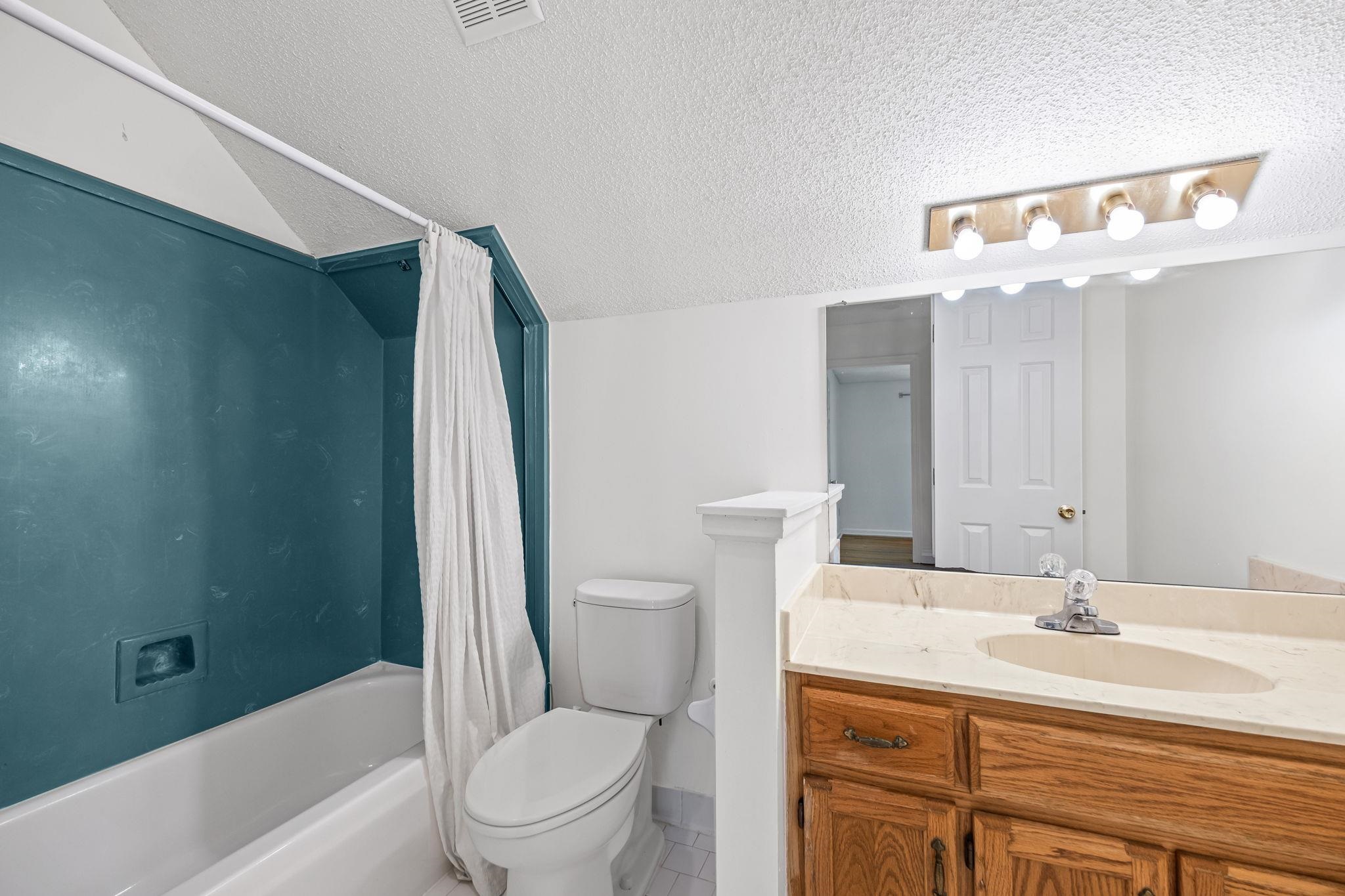 10661 Chapel Hill Road Lakeland, TN 38002 - Photo 32 of 40 a bathroom with a sink a toilet and shower