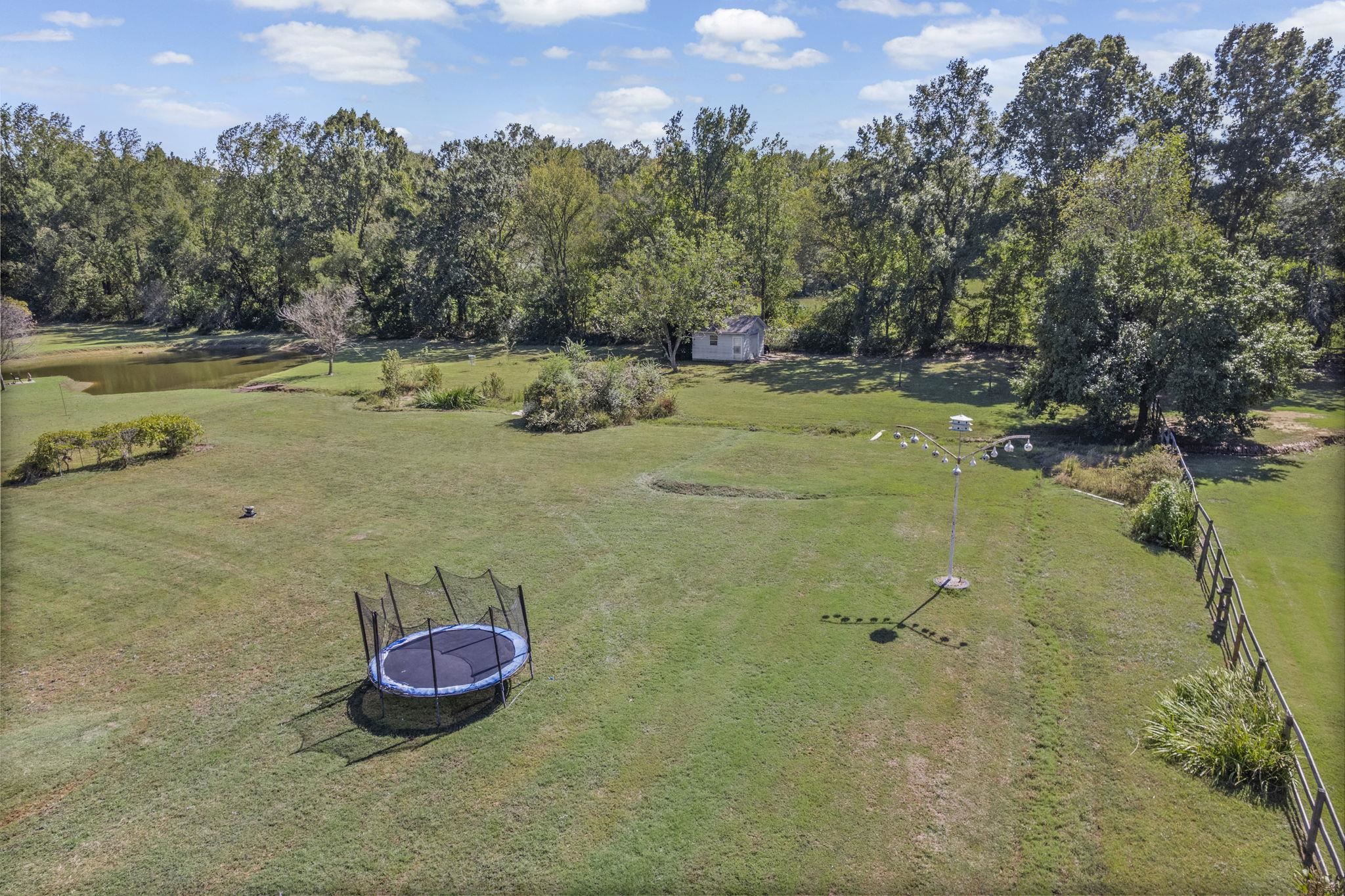 10661 Chapel Hill Road Lakeland, TN 38002 - Photo 5 of 40 a view of a backyard with a table and chairs