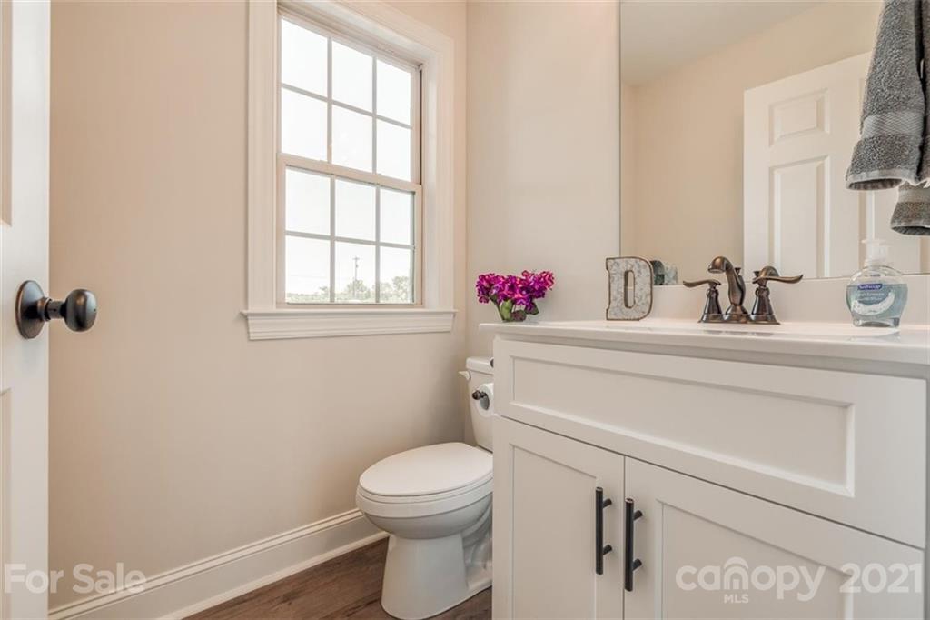 5809 Sikes Mill Road Monroe, NC 28110 - Photo 13 of 32 a bathroom with a sink mirror vanity and toilet