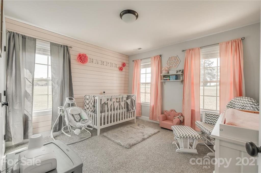 5809 Sikes Mill Road Monroe, NC 28110 - Photo 14 of 32 a bedroom with furniture and a window