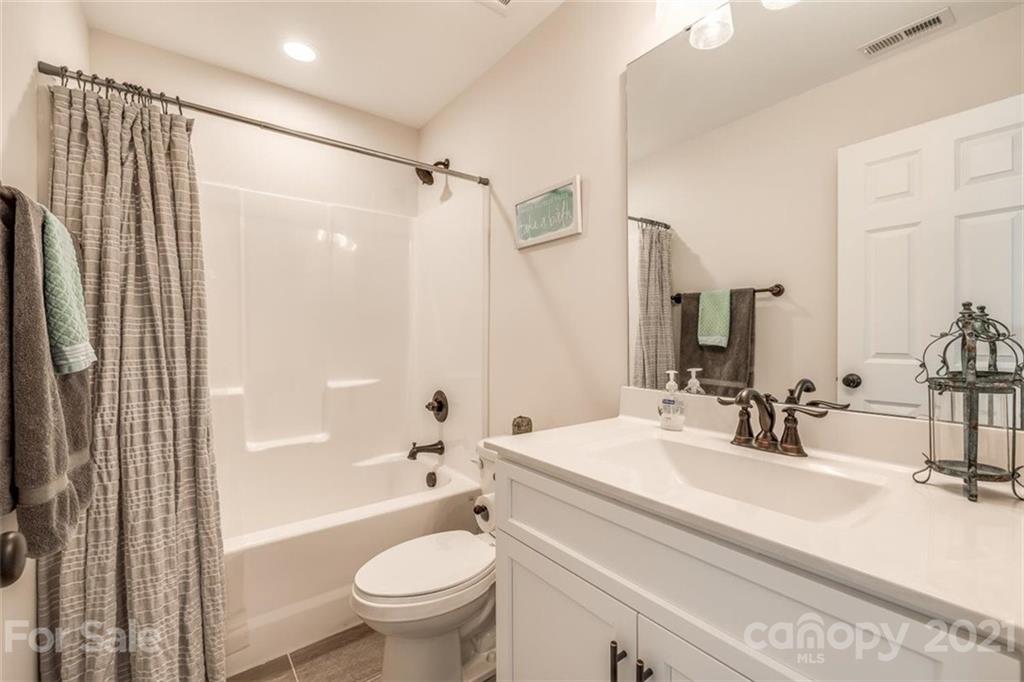 5809 Sikes Mill Road Monroe, NC 28110 - Photo 15 of 32 a bathroom with a sink toilet and shower