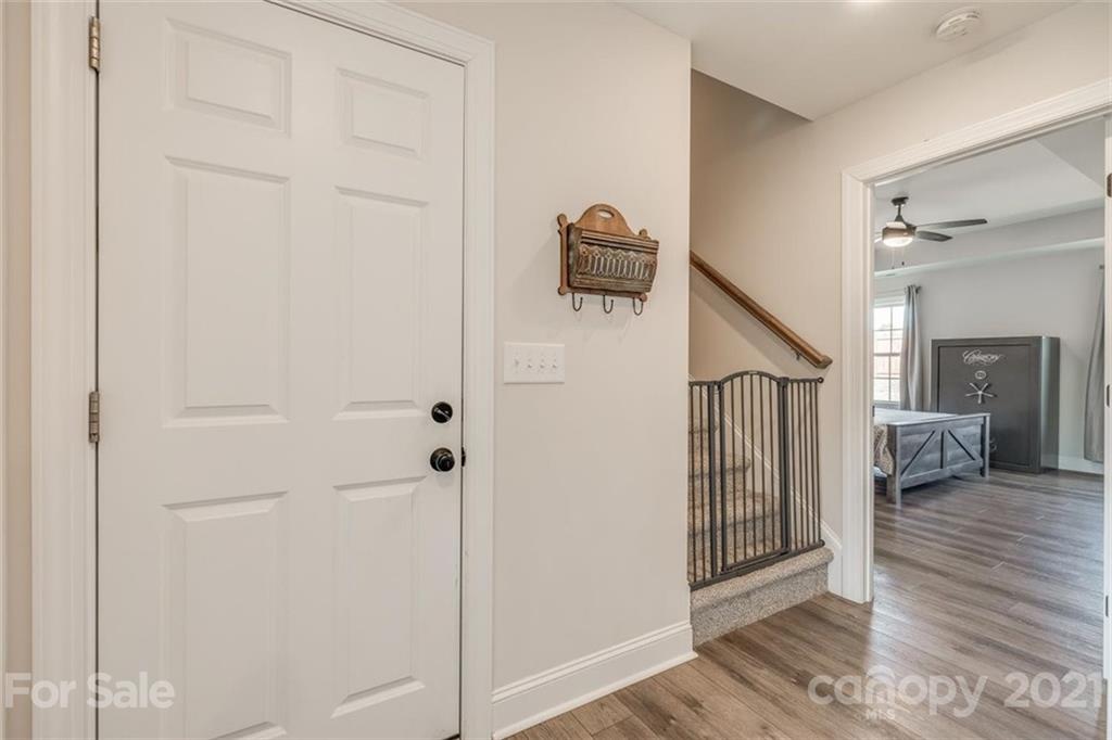 5809 Sikes Mill Road Monroe, NC 28110 - Photo 17 of 32 a view of a hallway with wooden floor and staircase