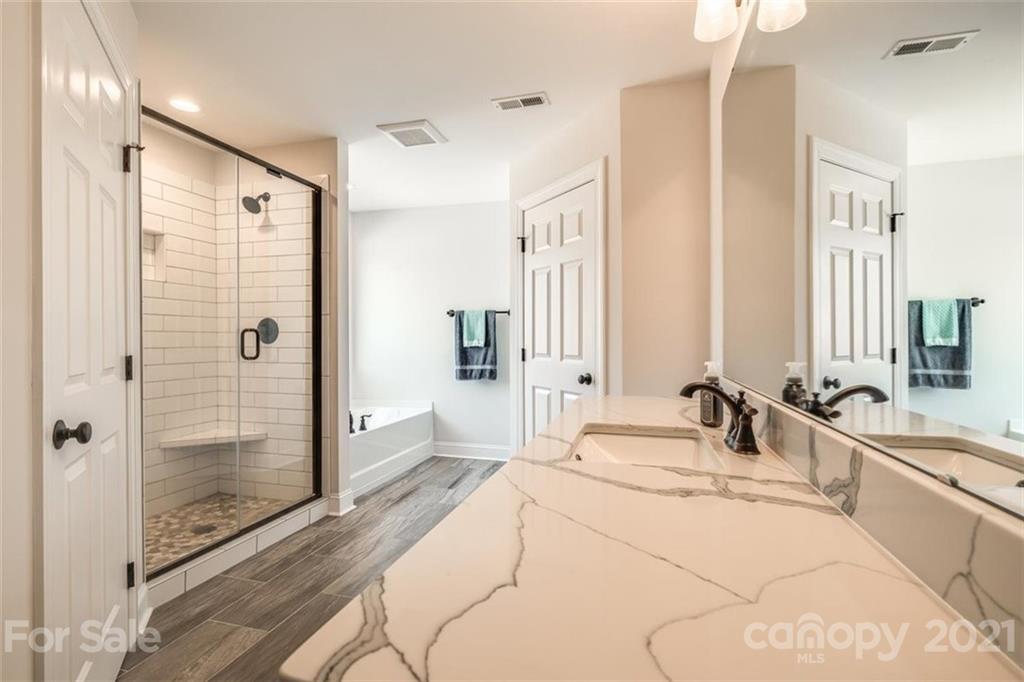 5809 Sikes Mill Road Monroe, NC 28110 - Photo 20 of 32 a bathroom with double vanity sinks and shower