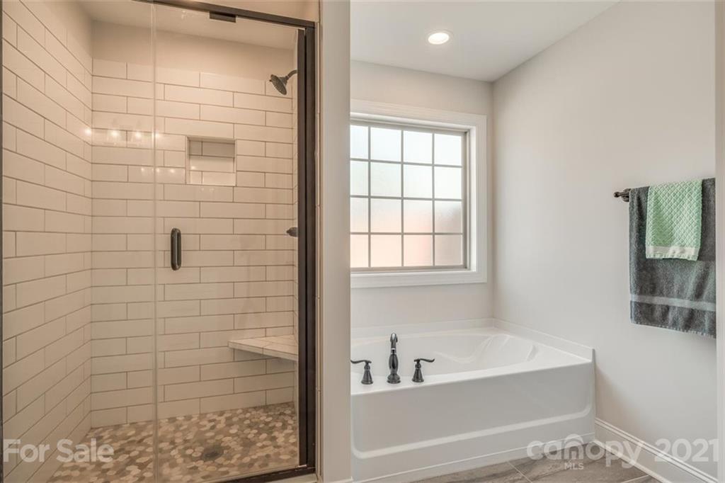 5809 Sikes Mill Road Monroe, NC 28110 - Photo 21 of 32 a bathroom with a bathtub and shower