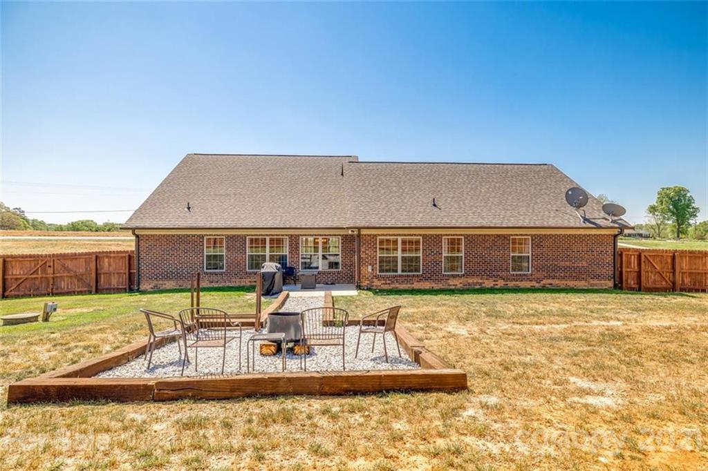 5809 Sikes Mill Road Monroe, NC 28110 - Photo 26 of 32 swimming pool view with a seating space and a garden view