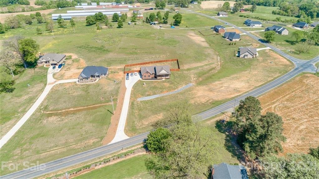 5809 Sikes Mill Road Monroe, NC 28110 - Photo 29 of 32 an aerial view of residential houses with outdoor space
