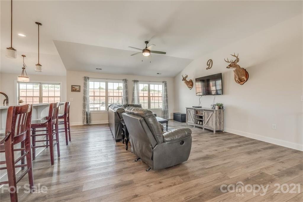 5809 Sikes Mill Road Monroe, NC 28110 - Photo 5 of 32 a living room with furniture a ceiling fan and a window