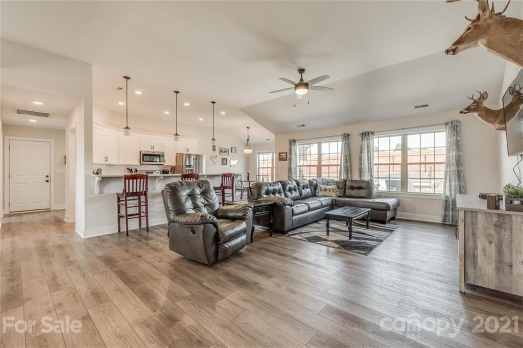 5809 Sikes Mill Road Monroe, NC 28110 - Photo 6 of 32 a living room with lots of furniture and kitchen view