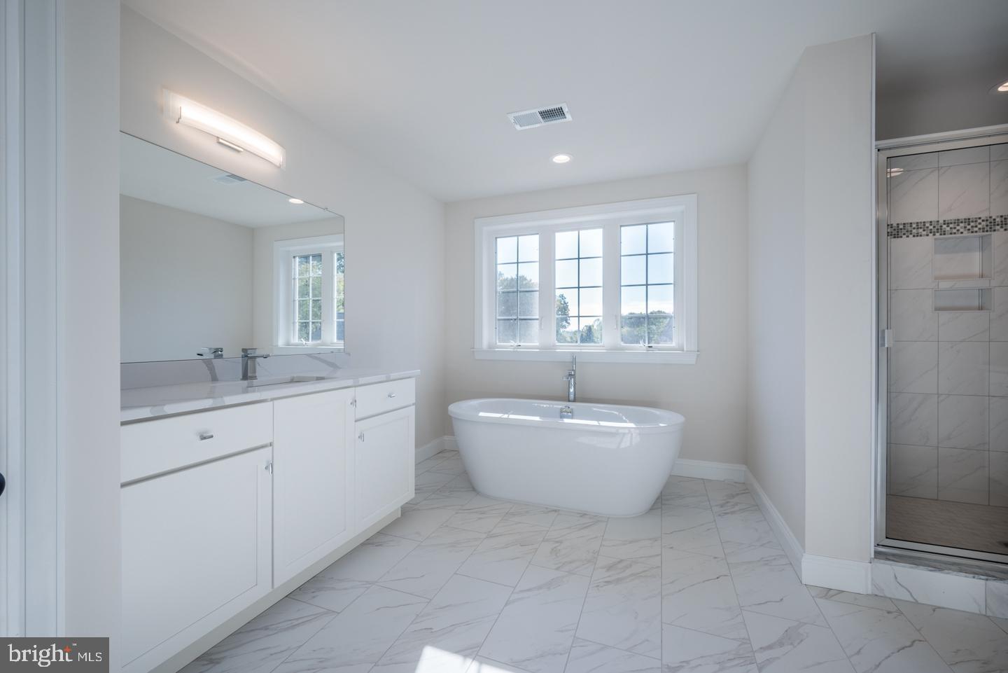 548 Old Forge Road, Unit 1 Media, PA 19063 - Photo 29 of 37 a spacious bathroom with a bathtub sink and mirror