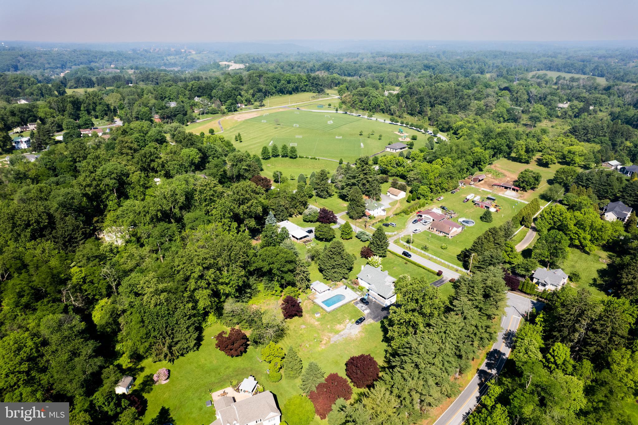 548 Old Forge Road, Unit 1 Media, PA 19063 - Photo 9 of 37 a view of a lush green forest with a house