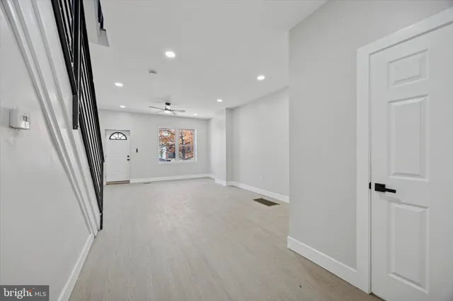 an empty room with windows and entrance