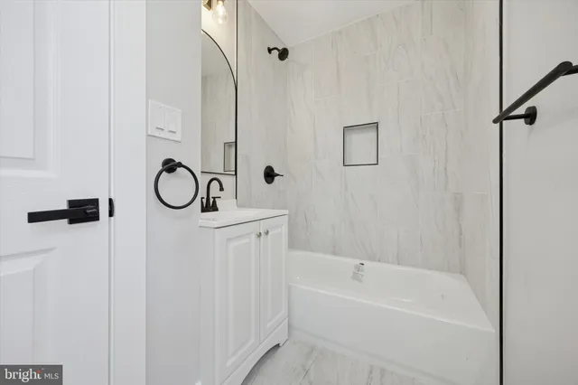 a bathroom with a bathtub a shower and a sink