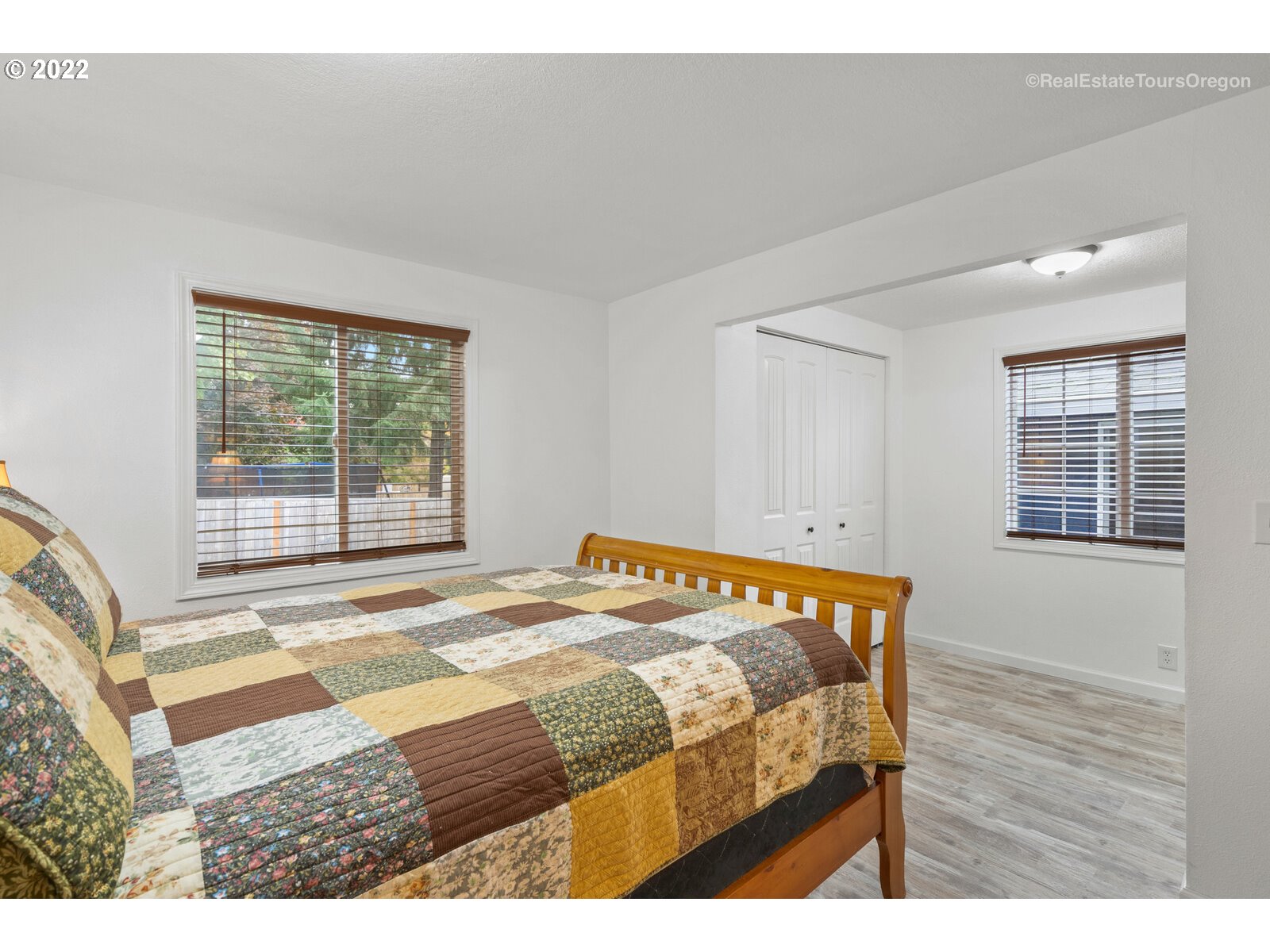 707 Roxe Drive Forest Grove, OR 97116 - Photo 14 of 32 a bedroom with a bed and wooden floor