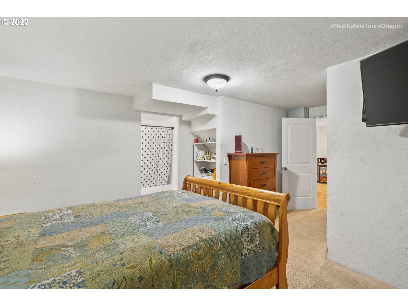 707 Roxe Drive Forest Grove, OR 97116 - Photo 19 of 32 a bedroom with a bed and a flat screen tv