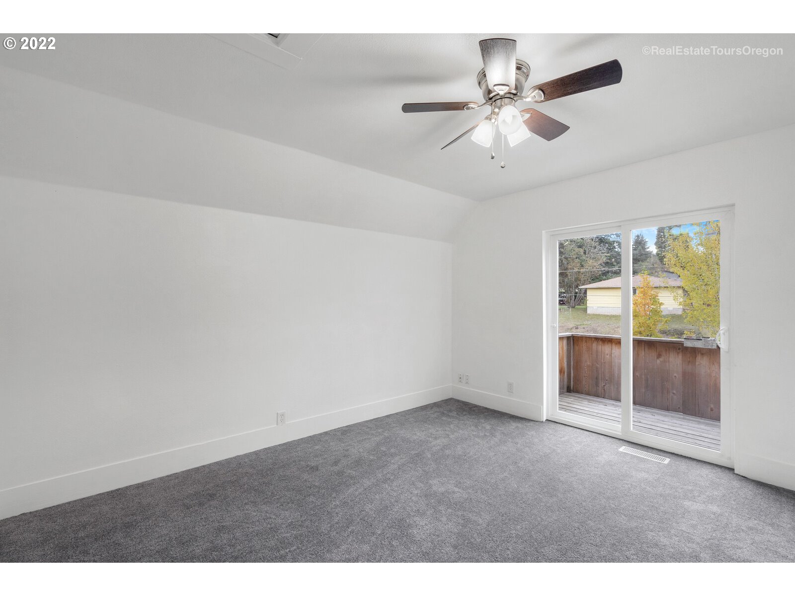 707 Roxe Drive Forest Grove, OR 97116 - Photo 23 of 32 a view of an empty room with cabinet and chandelier fan