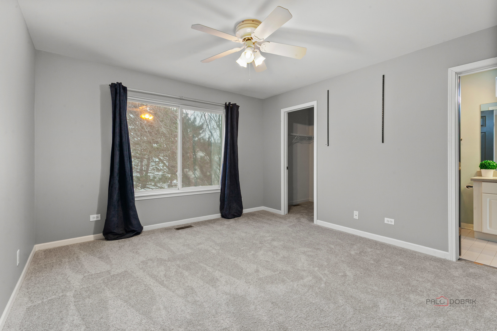 597 Treetop Lane Gurnee, IL 60031 - Photo 20 of 34 a view of a big room with windows and chandelier fan