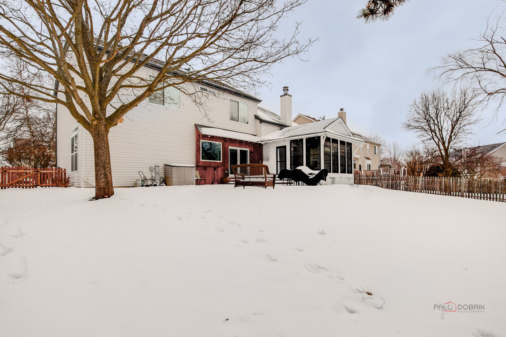 597 Treetop Lane Gurnee, IL 60031 - Photo 30 of 34 a view of a white house with a large tree in front of it