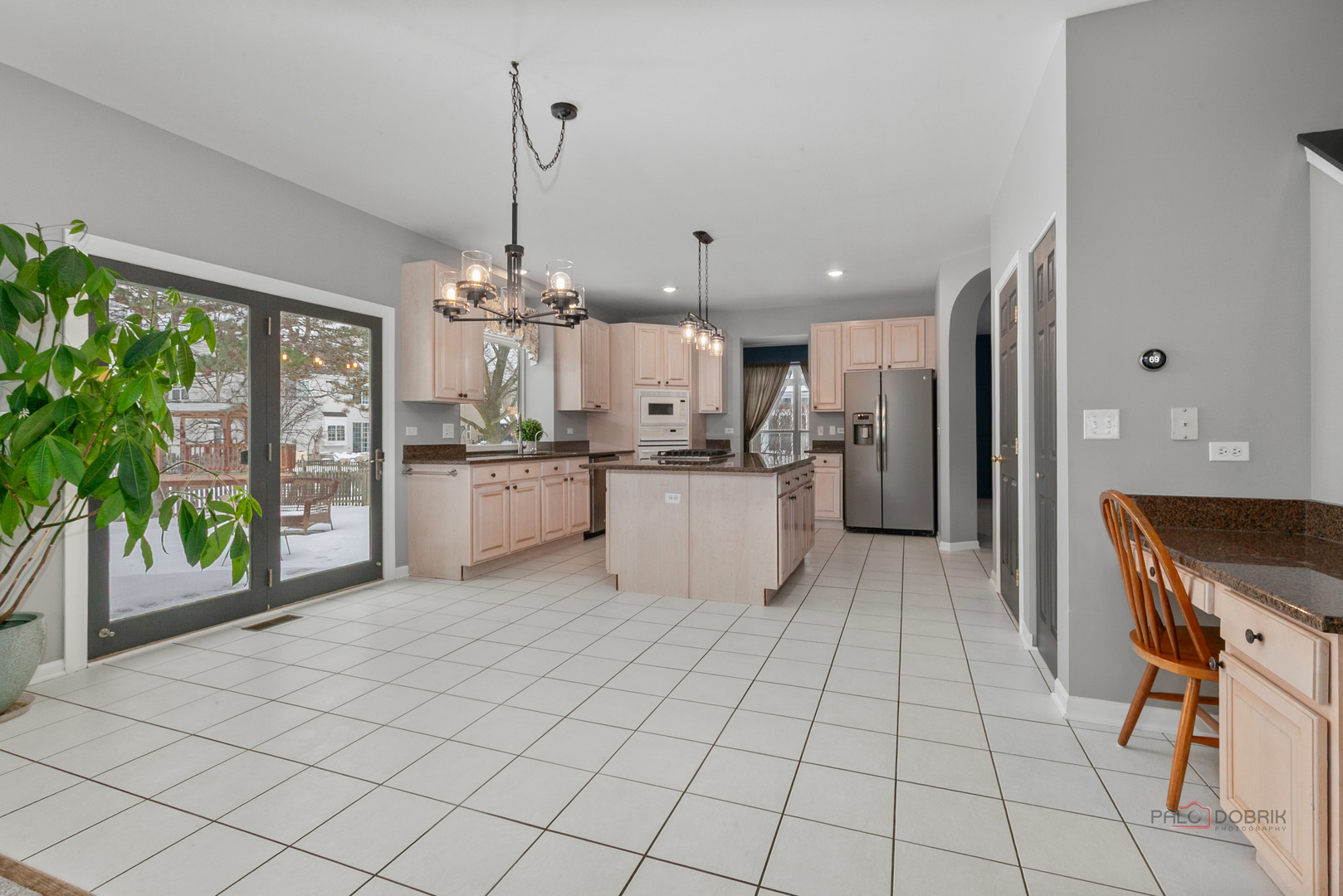597 Treetop Lane Gurnee, IL 60031 - Photo 7 of 34 a kitchen with stainless steel appliances granite countertop a refrigerator oven a sink dishwasher and a dining table with the view of kitchen