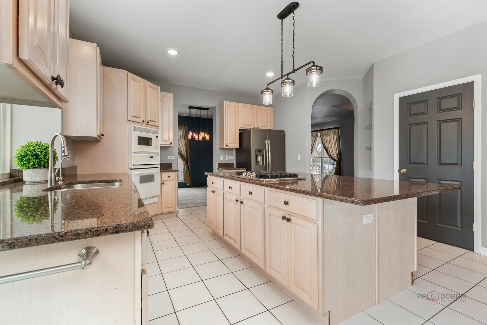 597 Treetop Lane Gurnee, IL 60031 - Photo 8 of 34 a kitchen with granite countertop a sink a counter top space appliances and cabinets