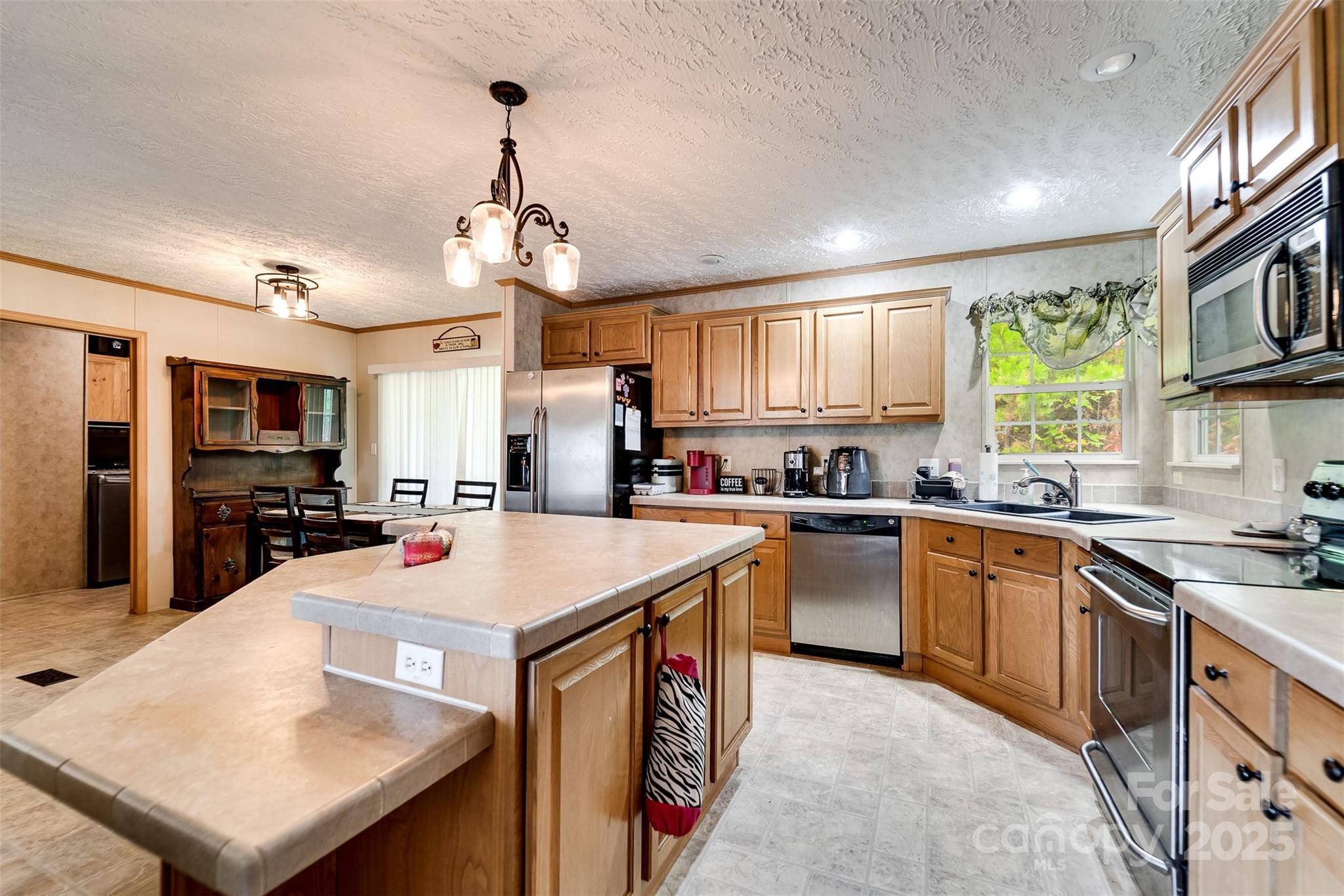 179 Fresh Water Rdg Road Whittier, NC 28789 - Photo 17 of 48 a kitchen with a stove a sink dishwasher a oven with a dining table and chairs