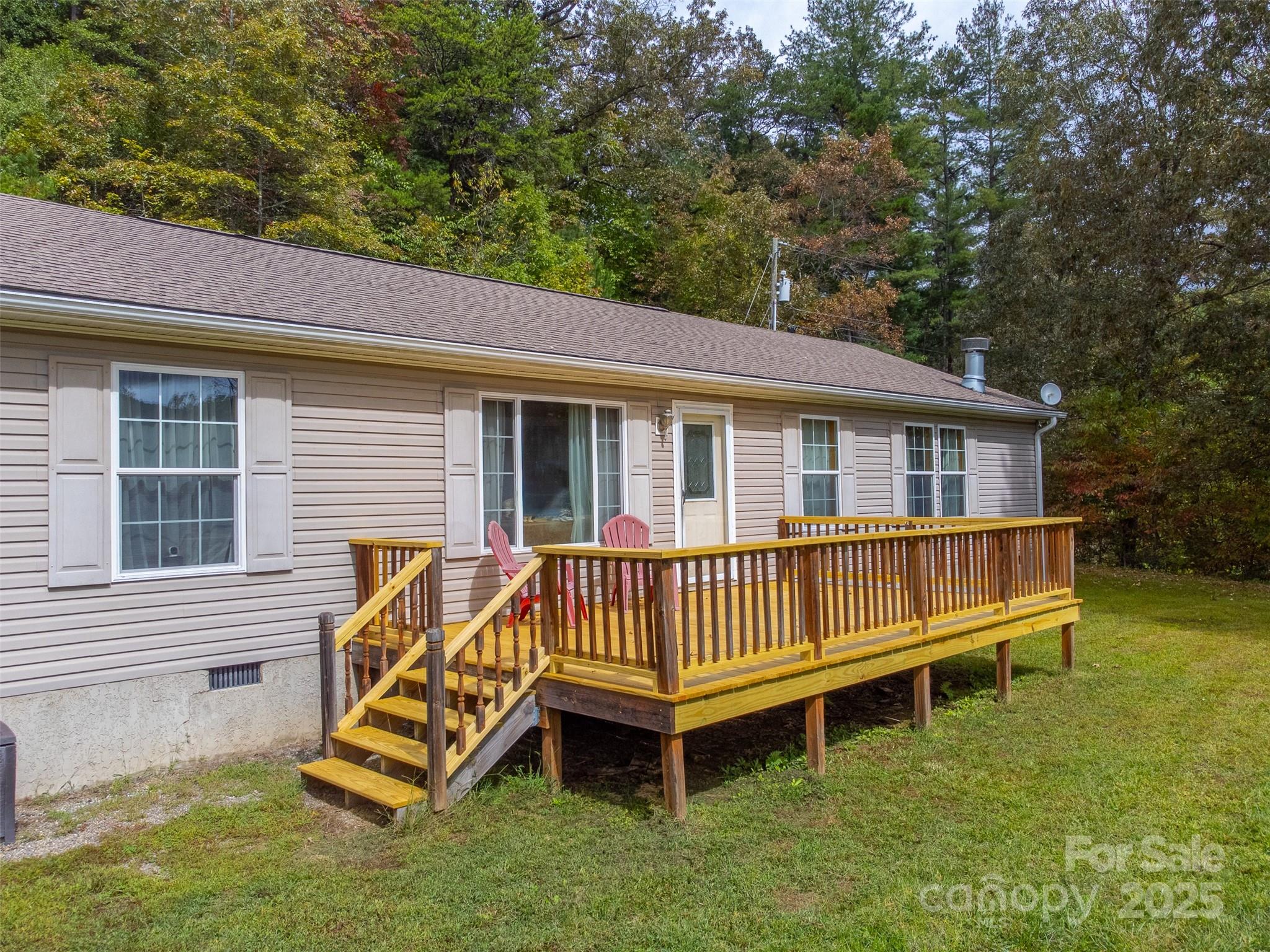 179 Fresh Water Rdg Road Whittier, NC 28789 - Photo 2 of 48 a view of a house with a yard and a wooden deck