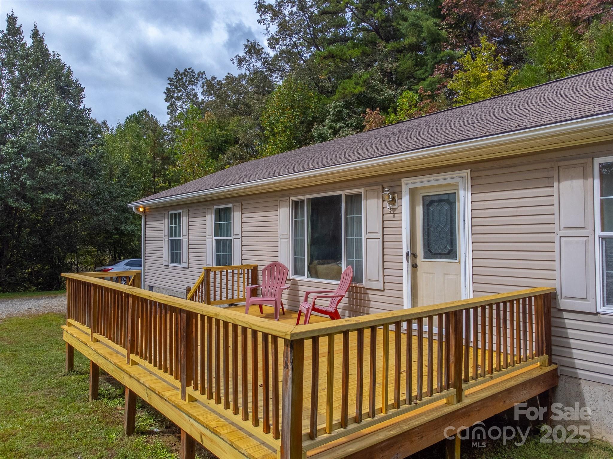 179 Fresh Water Rdg Road Whittier, NC 28789 - Photo 3 of 48 a view of deck with two chairs and a large window