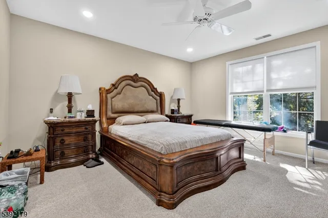 a bedroom with a bed and a large window