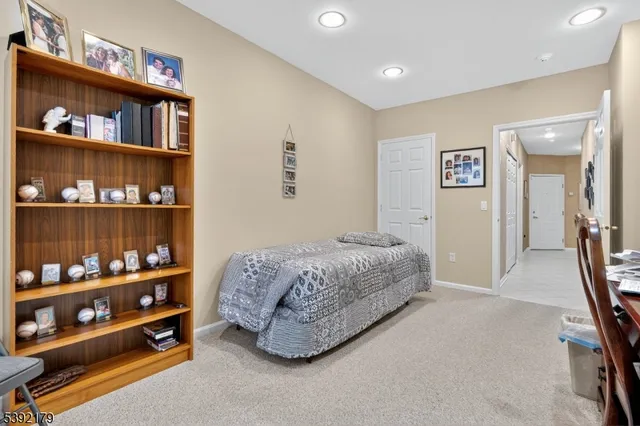 a bedroom with a bed and a book shelf