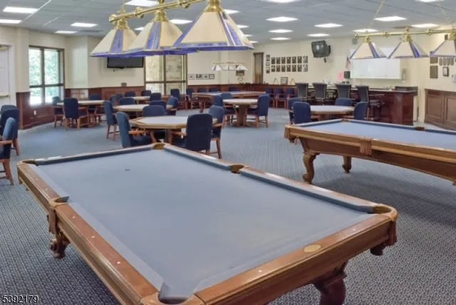 a living room with lots of furniture and a chandelier