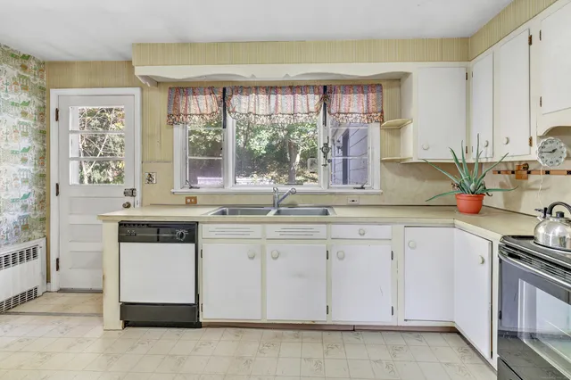 a kitchen with granite countertop a sink and a window